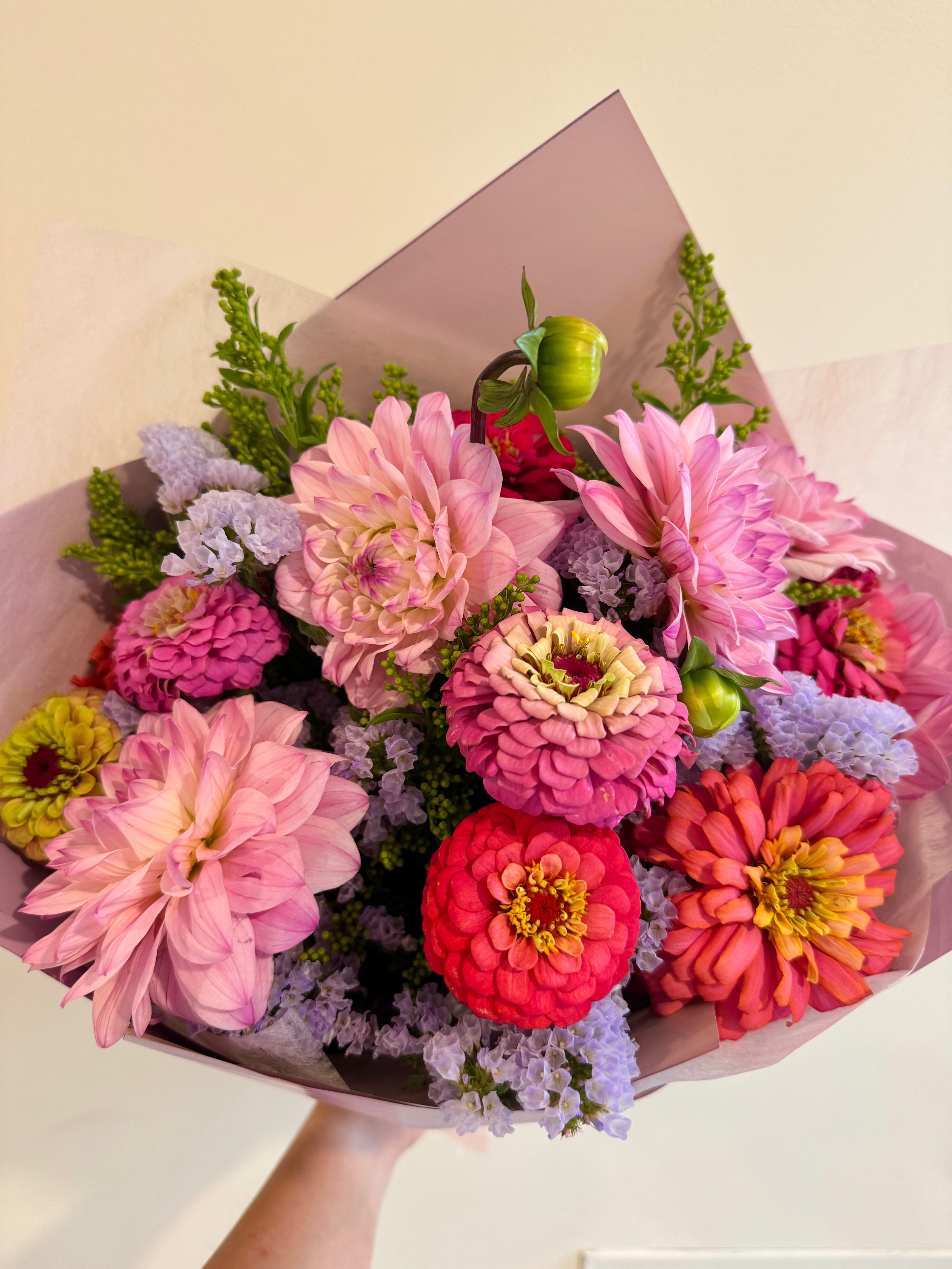 Bouquet of colorful dahlia and zinnia flowers in pink, red, green, and yellow
